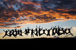 silhouetted large group of teens jumping after sunset silhouetted large group of teens jumping after sunset