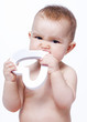 baby testing his teeth on a heart