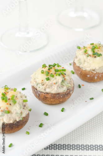Photo: Stuffed mushrooms, baked with cheese and herbs, selective focus Stuffed mushrooms, baked with cheese and herbs, selective focus