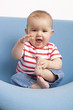 laughing baby girl learning how to stand up