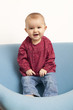 laughing baby girl learning how to stand up
