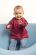 happy baby dancing on a sofa