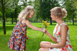 girl gives a flowers to her mother