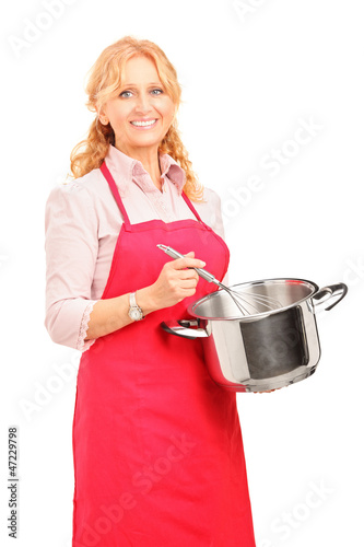 Photo: Beautiful woman holding a pot and kitchen utensil Beautiful woman holding a pot and kitchen utensil