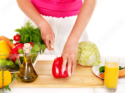Photo: Pregnant woman preparing food . Pregnant woman preparing food .