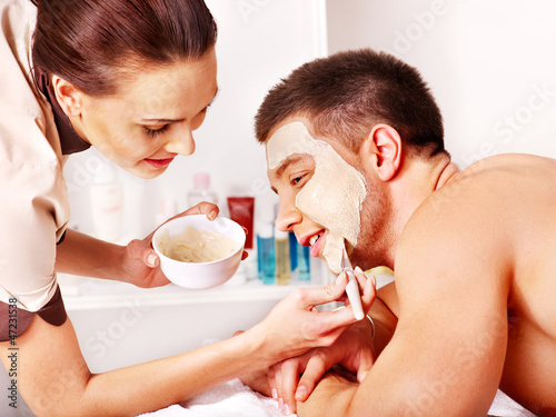 Photo: Clay facial mask in beauty spa. Clay facial mask in beauty spa.