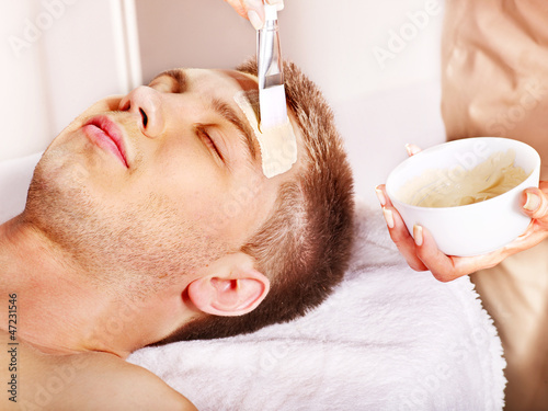 Photo: Clay facial mask in beauty spa. Clay facial mask in beauty spa.