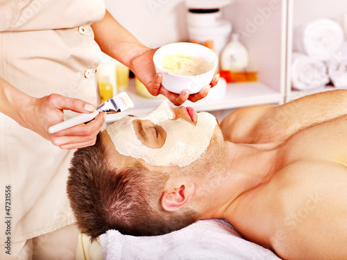 Photo: Clay facial mask in beauty spa. Clay facial mask in beauty spa.