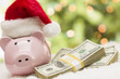 Photo: Pink Piggy Bank Wearing Santa Hat Near Stacks of Money on Snowfl Pink Piggy Bank Wearing Santa Hat Near Stacks of Money on Snowfl