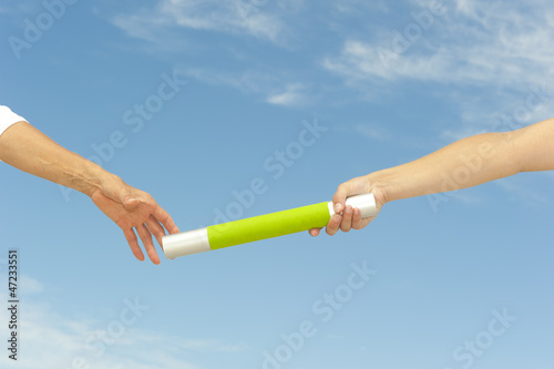 Photo: Hands reaching baton for teamwork Hands reaching baton for teamwork