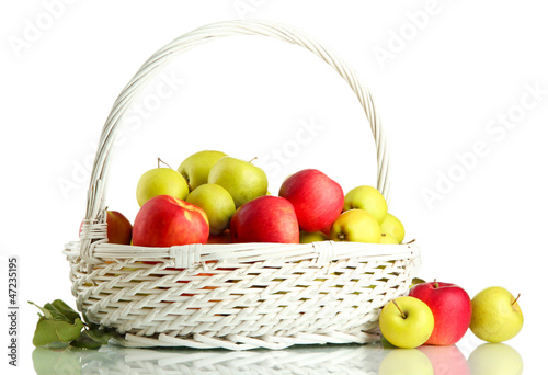 Photo: juicy apples with green leaves in basket, isolated on white juicy apples with green leaves in basket, isolated on white