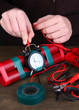 Human makes timebomb on wooden table on black background