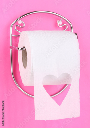 Photo: Roll of toilet paper on holder fixed to wall Roll of toilet paper on holder fixed to wall