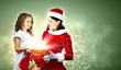 Little girl with christmas gifts and santa
