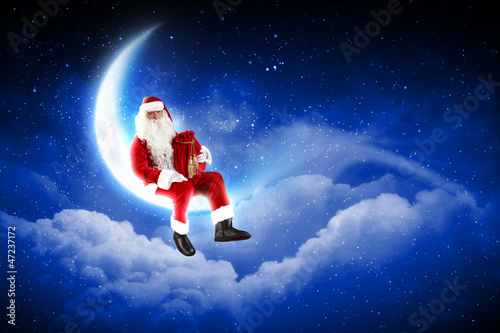 Photo: photo of santa claus sitting on the moon photo of santa claus sitting on the moon