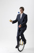 Juggling Businessman On Unicycle