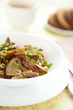 Fried mushrooms - chanterelles and onions in a white bowl