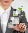 Young business woman pushing a button on a virtual touch screen
