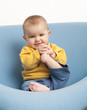 baby playing at eating his feet