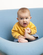baby playing at eating his feet