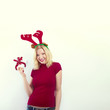beautiful blonde woman with reindeer antlers is smiling