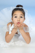 Beautiful little dancer, ballerina in white dress over blue