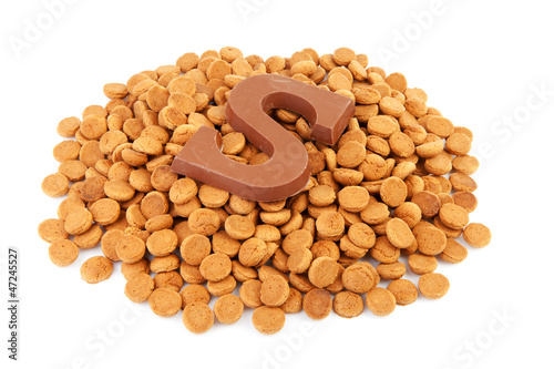 Photo: Ginger nuts, pepernoten, and chocolate letter S isolated Ginger nuts, pepernoten, and chocolate letter S isolated