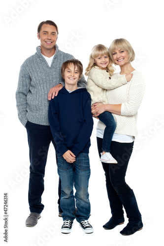 Photo: Happy family posing in trendy winter wear outfits Happy family posing in trendy winter wear outfits