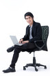 Happy  business man sitting in a chair and working with laptop