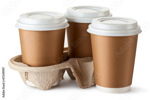 Photo: Three take-out coffee. Two cups in holder. Three take-out coffee. Two cups in holder.