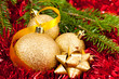 Christmas ornaments - golden baubles with shiny tape in backgrou