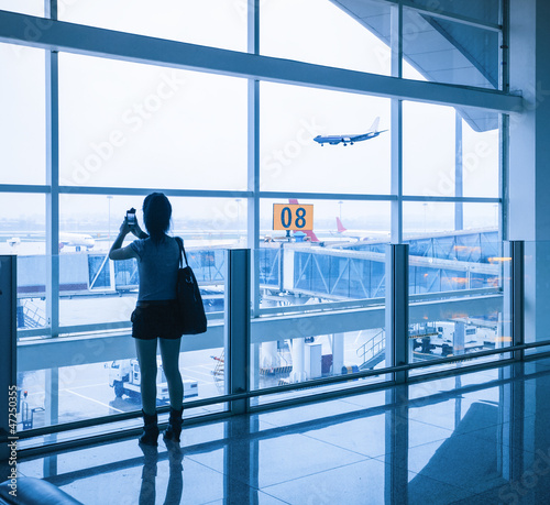 Photo: young girl at the airport window and flight arrival young girl at the airport window and flight arrival