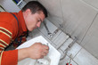 Photo: Plumber fixing water tap on bidet in a washroom Plumber fixing water tap on bidet in a washroom