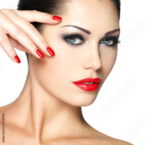 Photo: Beautiful woman with red nails and fashion makeup Beautiful woman with red nails and fashion makeup