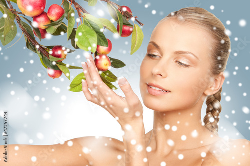 Photo: lovely woman with apple twig lovely woman with apple twig