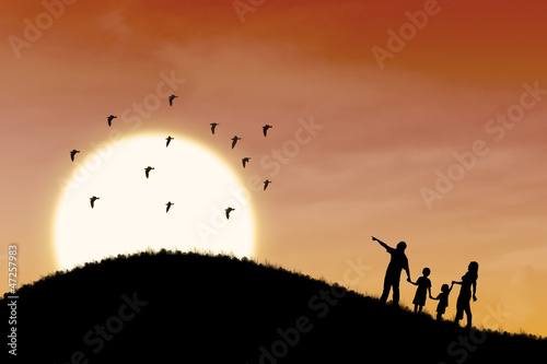 Illustration: Happy family silhouette with sunset landscape Happy family silhouette with sunset landscape