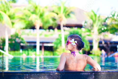 Photo: portrait of young attraactive smiling woman in luxury pool portrait of young attraactive smiling woman in luxury pool