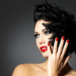 Woman with red nails and creative hairstyle