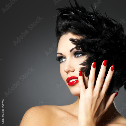 Photo: Woman with red nails and creative hairstyle Woman with red nails and creative hairstyle