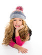Kid girl with winter wool cap smiling on white