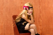 blond fashin kid girl sitting on retro vintage seat