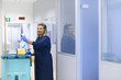 Portrait of happy professional female cleaner smiling in office