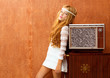 Photo: Blond vintage 70s kid girl with retro wood tv Blond vintage 70s kid girl with retro wood tv