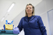 Portrait of happy professional female cleaner smiling in office