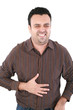 Photo: Young man suffering from a bad stomach ache pain isolated on whi Young man suffering from a bad stomach ache pain isolated on whi