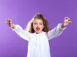 Photo: Children vampire makeup kid girl on purple Children vampire makeup kid girl on purple