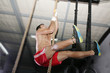 Crossfit rope climb exercise.  Focus in the body.