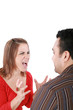 Photo: Young couple in conflict shouting isolated on white background. Young couple in conflict shouting isolated on white background.