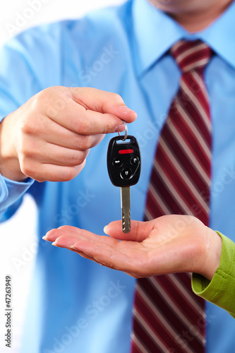Photo: Hand with a car key. Hand with a car key.