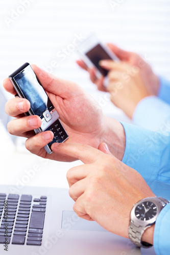 Photo: Business people calling by smartphone. Business people calling by smartphone.